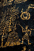 Wat Xieng Thong temple in Luang Prabang, Laos. Detail of the  intricate gold stencilling on black lacquer that decorate the walls of the sim. 